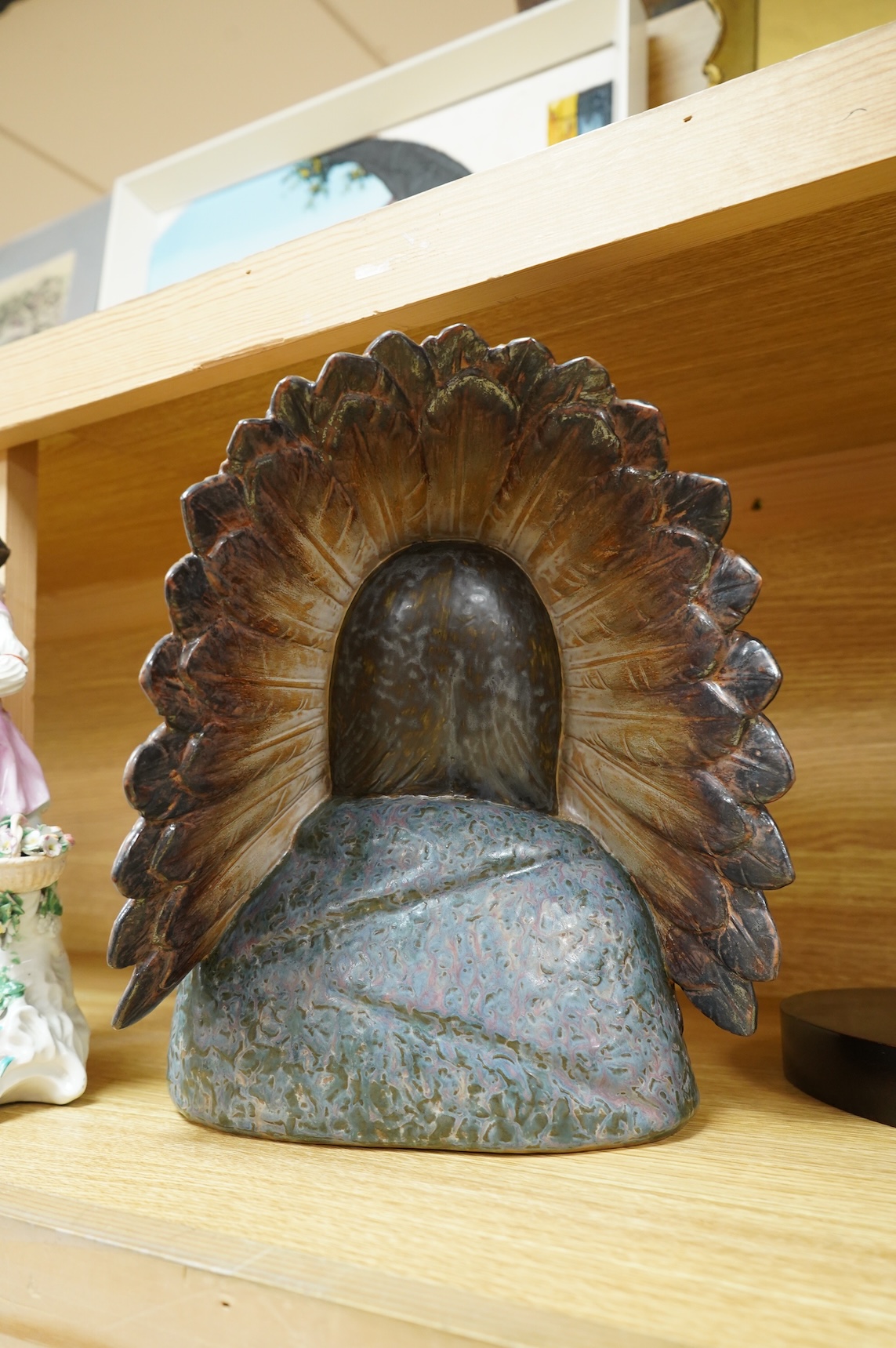 A Lladro bust of a native America chief with feather tribal headdress, 29cm high. (Bust on stand)